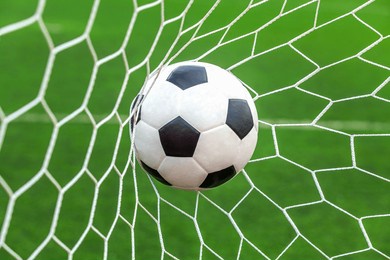 soccer ball on goal with net background, football player shoot a leather foot ball for make a score