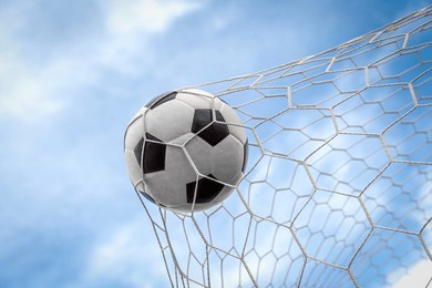 soccer ball on goal with net background, football player shoot a leather foot ball for make a score