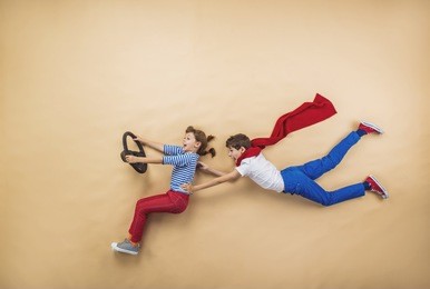funny children are playing together. lying on the floor.
