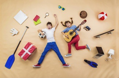funny children are playing together. lying on the floor with guitar and ball
