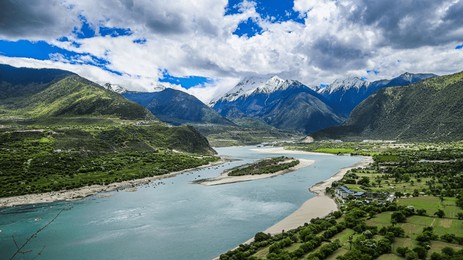 a beautiful view of yarlung zangbo river in tibet with mountains in the background