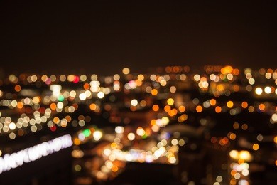 defocused bokeh of light in city on yellow background