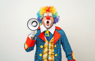 mr clown. funny shocked face comedian clown man in colorful costume wearing wig shout out loud wow with megaphone mouth announcement. happy expression amazed bozo in various pose on isolated.