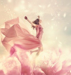 beautiful young woman jumping on a giant flower