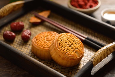 the mid-autumn festival moon cake on the retro background. the chinese meaning of the moon cake in the picture is: fine five kernels, black sesame, representing the taste of mooncakes