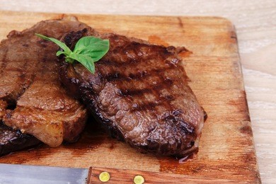 served beef meat barbecue on wooden plate with cutlery