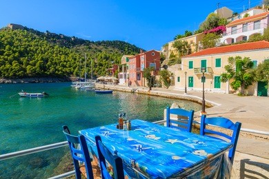 table in greek tavern on coast of kefalonia island in assos fishing village, greece