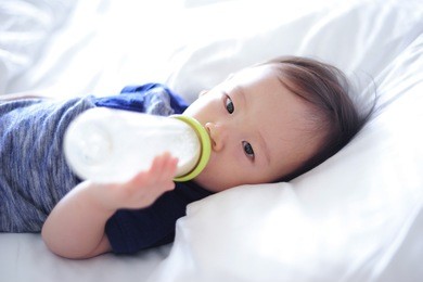 baby drinking milk from bottle