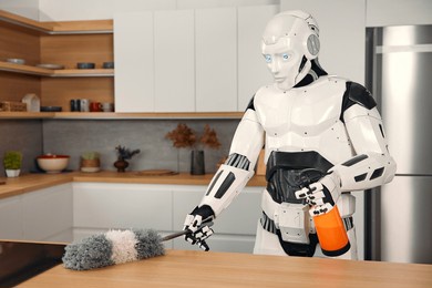 robot housekeeper doing cleaning in the kitchen cleaning the table and stove. living together between humans and artificial intelligence.