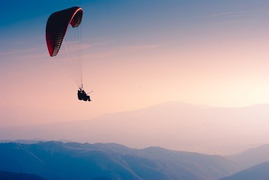 paraglide in a sky above carpathian mountains