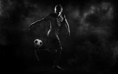bright soccer playerl on the black background