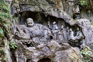 feilai feng grottoes with fine buddhist stone carvings. it is called 'the peak that flew hither" or "flying peak" and is located in front of the lingyin temple. 
