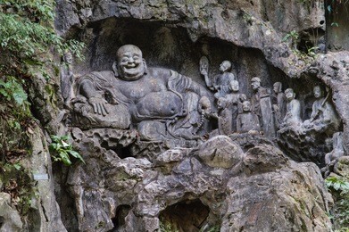 feilai feng grottoes with fine buddhist stone carvings. it is called 'the peak that flew hither" or "flying peak" and is located in front of the lingyin temple. 