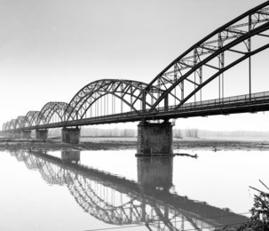 the iron "gerola bridge" on the po river, lombardy (northern italy, in the province of pavia). black and white photo
