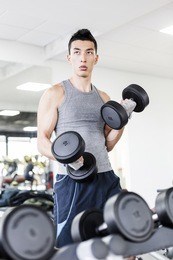asian man doing exercises in a gym.