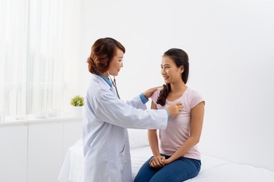 vietnamese doctor listening heartbeat of her young patient