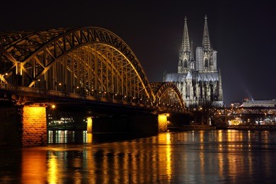 panoramic rhine river view on cologne cathedral and hohenzollern railway bridge at night