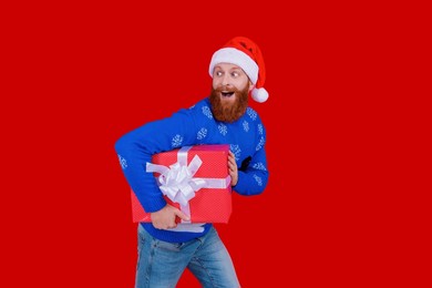 santa man hold holiday shopping gift. xmas present and gift. christmas shopping sale. happy new year. xmas holiday present. santa claus man hurry for new year sale. send christmas cards