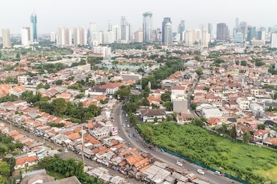 residential area right in the center of jakarta, the capital city of indonesia. the city is still composed of lots of villages in the center which contrast sharply with the modern buildings.
