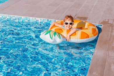 little girl having fun in swimming pool. summer outdoor activity during family vacation.
