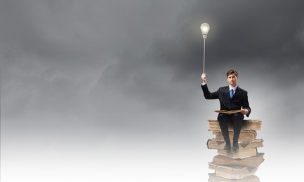 handsome businessman sitting on top and reading book