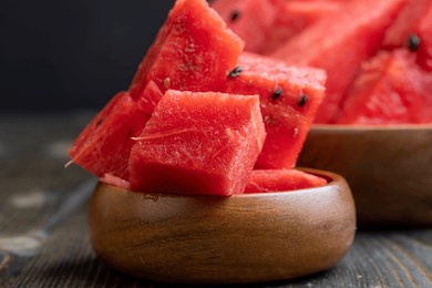 sliced red and ripe watermelon on the table, juicy pieces of watermelon sliced on a black board