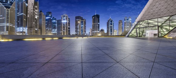 city square floor and modern commercial building scenery at night in shanghai, china. famous financial district buildings in shanghai.