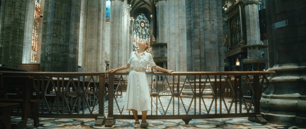 woman traveler looking at ancient architecture of basilica. girl visiting historical sights while traveling.