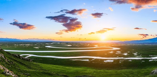 curved river and green grassland natural landscape at sunset in xinjiang. beautiful grassland natural scenery in summer. famous travel destination.