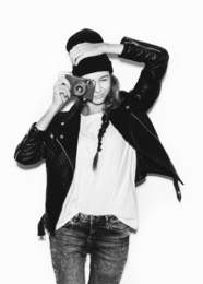 young woman making photo using noname retro camera. black white portrait on white background not isolated