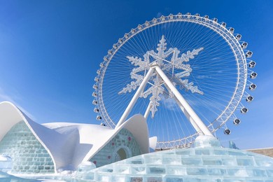 the giant snow ferris wheel in harbin international ice and snow sculpture festival at harbin, china. it is the world largest ice and snow festival.