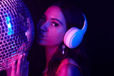 night club dj in headphones kissing disco ball