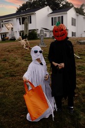 kids dressed in halloween costumes trick-or-treaters