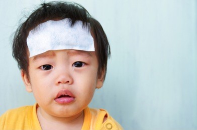 baby illness medicine flu fever and cooling forehead.