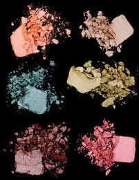 close up of a make up powder on black background