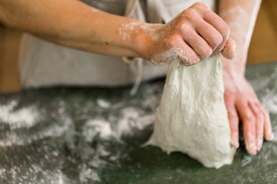 young baker preparing artisan sourdough bread.