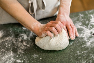 young baker preparing artisan sourdough bread.
