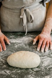 young baker preparing artisan sourdough bread.
