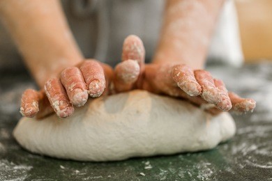 young baker preparing artisan sourdough bread.