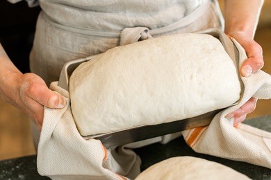 young baker preparing artisan sourdough bread.
