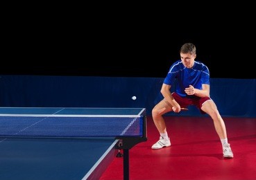 table tennis player isolated on black