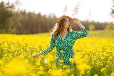 happy woman enjoying nature on the field. nature, vacation, relax and lifestyle. summer landscape.