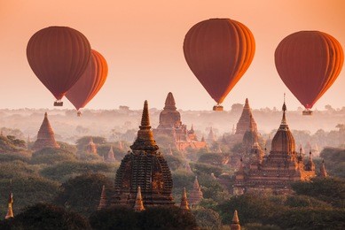 hot air balloon over plain of bagan in misty morning, myanmar
