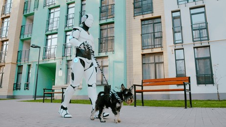 side view of happy scottish terrier dog walking with humanoid robot cyborg with leash on street outdoors. concept of technology evolution, domestic animals and futuristic technology.