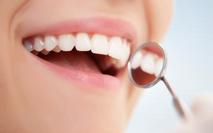 close-up of young female having her teeth examinated