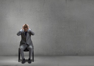 young troubled businessman with hands on his head