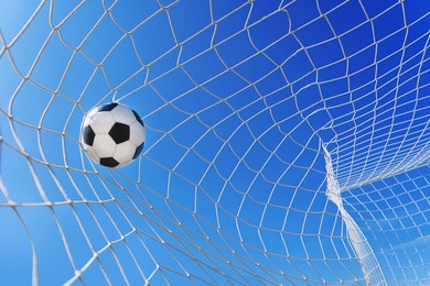  soccer ball in soccer goal net in a big stadium isolated on blue sky. soccer net.