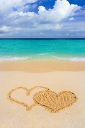 drawing connected hearts on beach, love concept