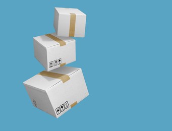 closed and taped white cardboard boxes flying isolated on turquoise blue background