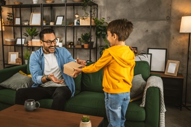 son give and share gift with his father and surprise him for birthday or fathers day